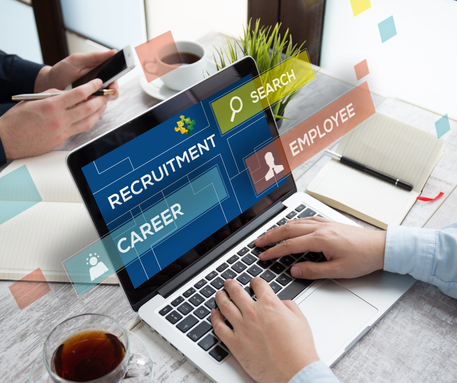 A Laptop on a table showing the words Recruitment, Career an Employee on its screen